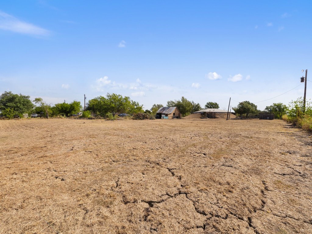 20416 Wilson Road Coupland, TX 78615 - Photo 37 of 39 A spacious open acreage offers expansive blue sky views and rustic outbuildings.