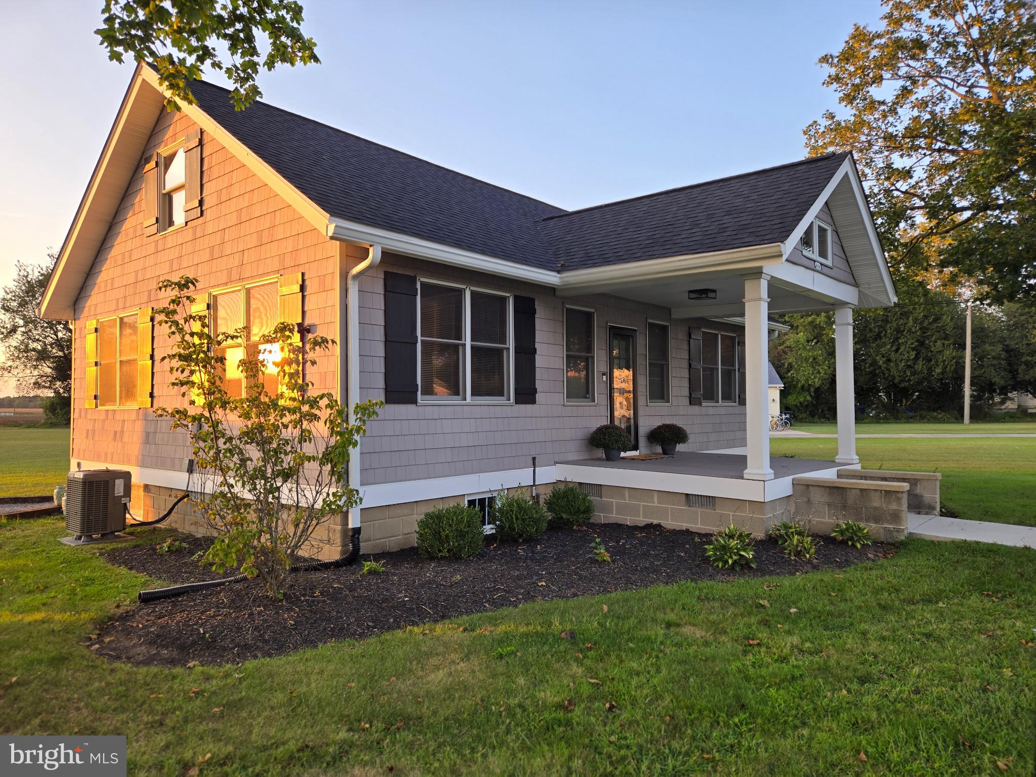 14198 Union Street Milton, DE 19968 - Photo 1 of 49 Charming home bathed in golden sunset light.