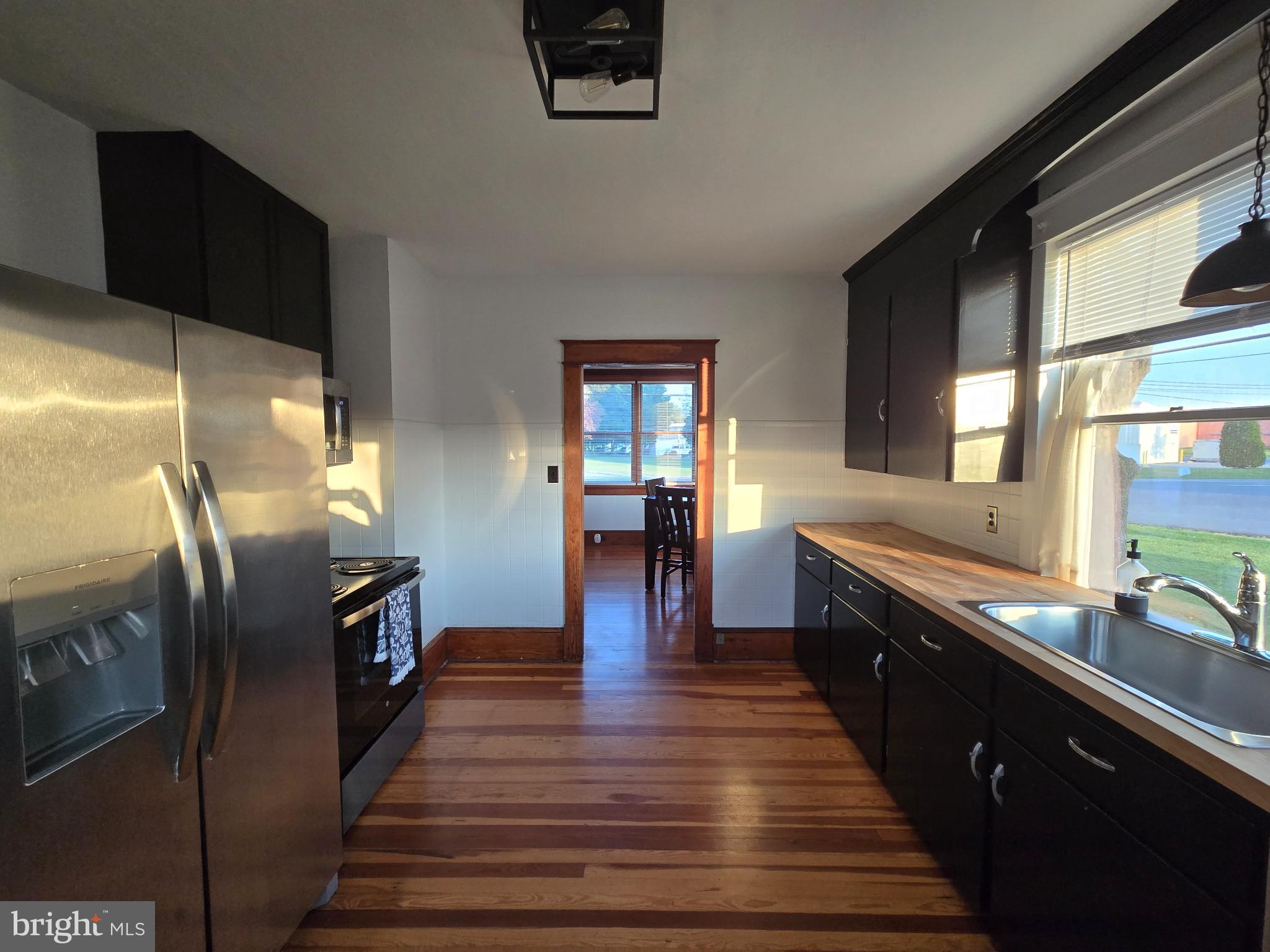 14198 Union Street Milton, DE 19968 - Photo 21 of 49 Modern kitchen with sleek black cabinetry.