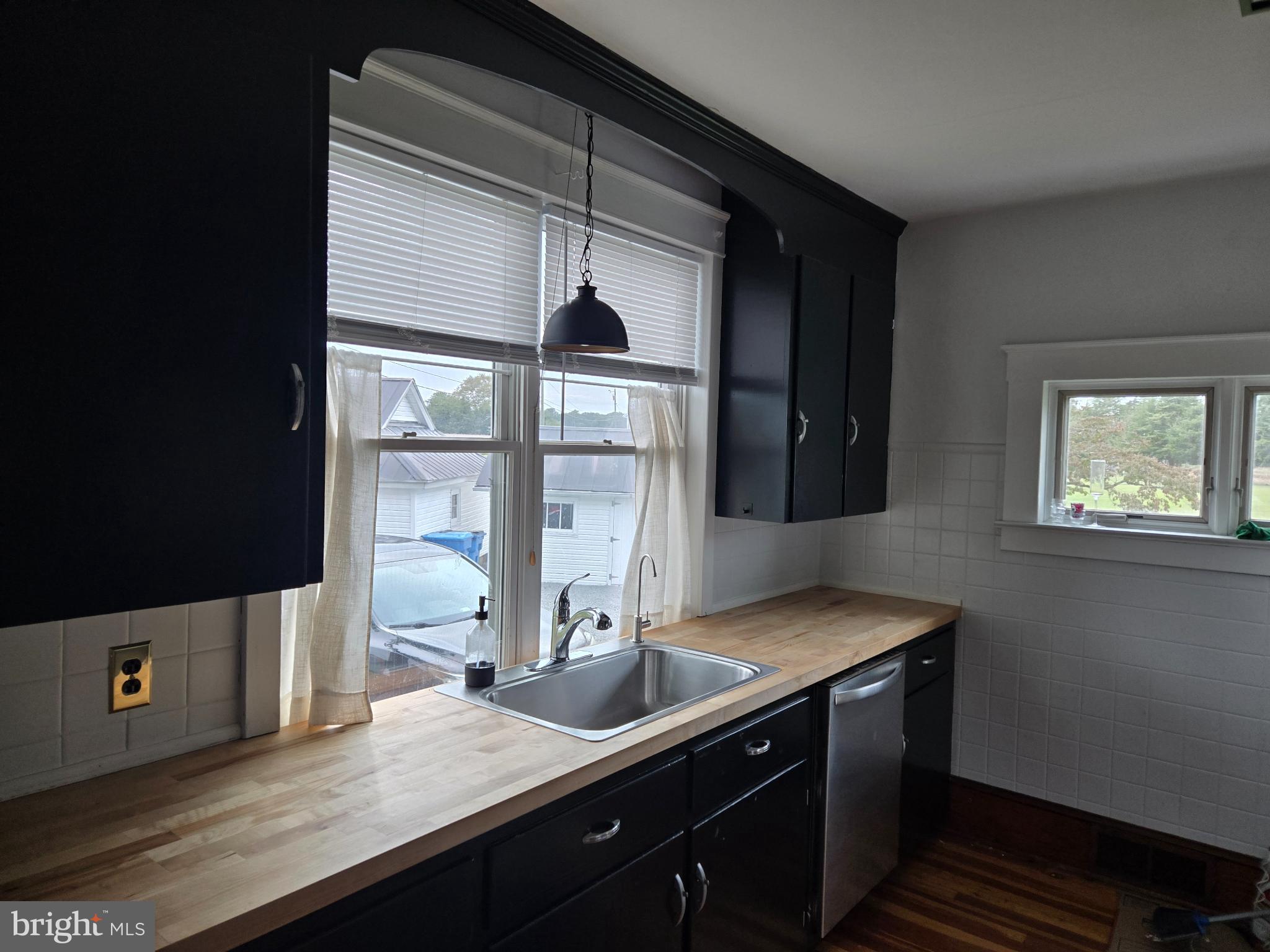 14198 Union Street Milton, DE 19968 - Photo 23 of 49 Modern kitchen with sleek black cabinetry.