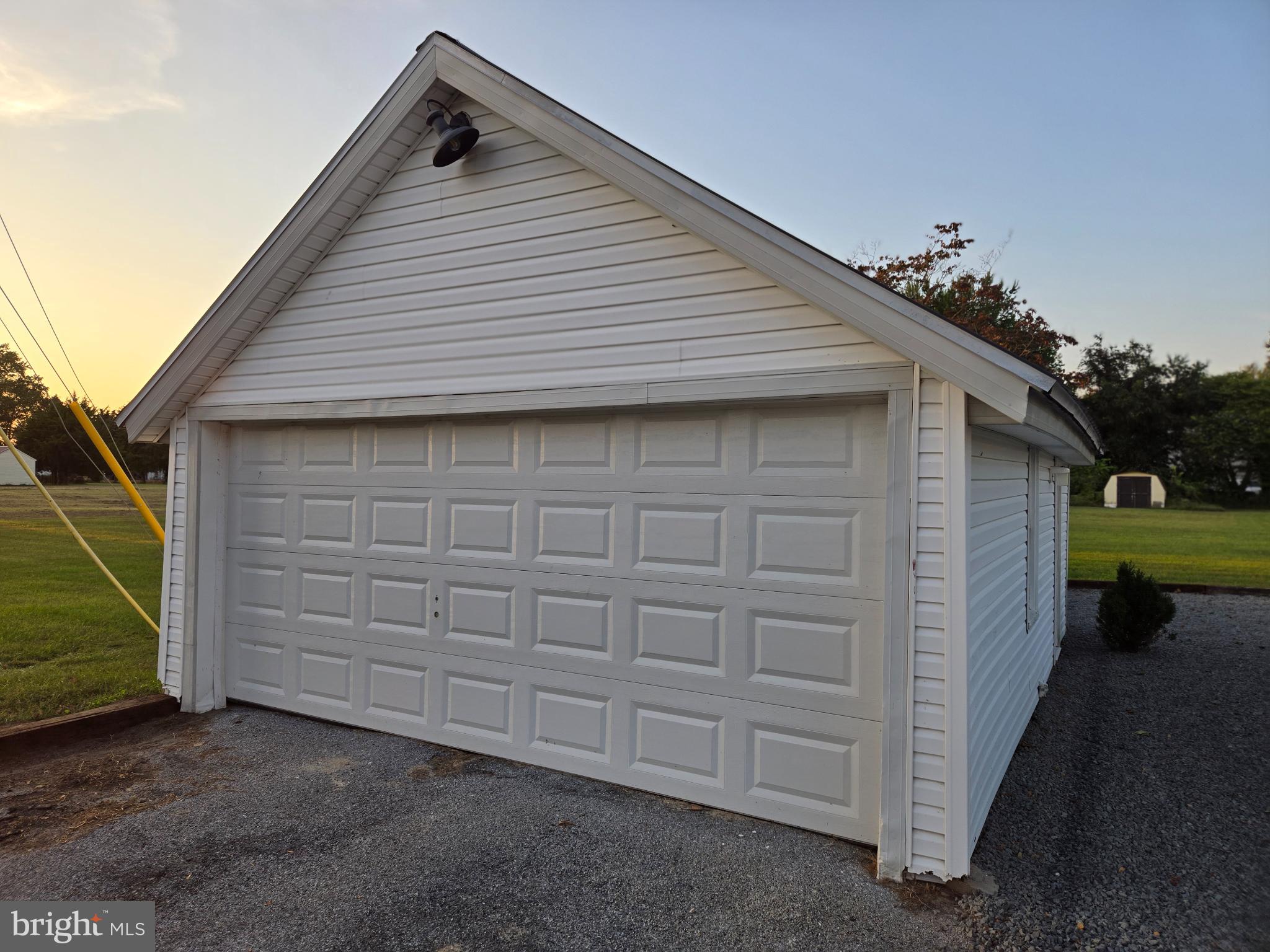 14198 Union Street Milton, DE 19968 - Photo 34 of 49 Charming garage with serene sunset backdrop.