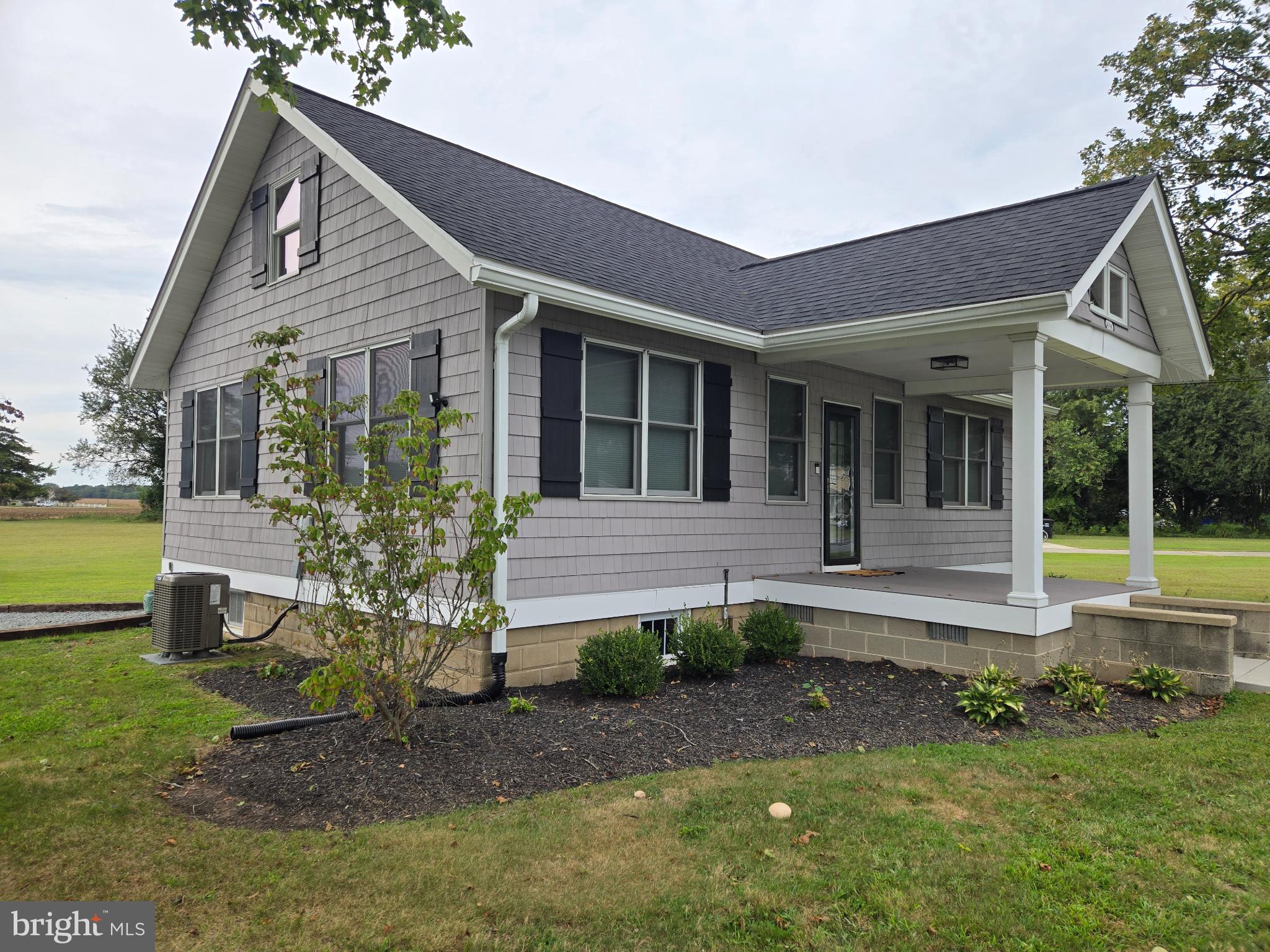 14198 Union Street Milton, DE 19968 - Photo 4 of 49 Charming gray cottage with lush greenery.