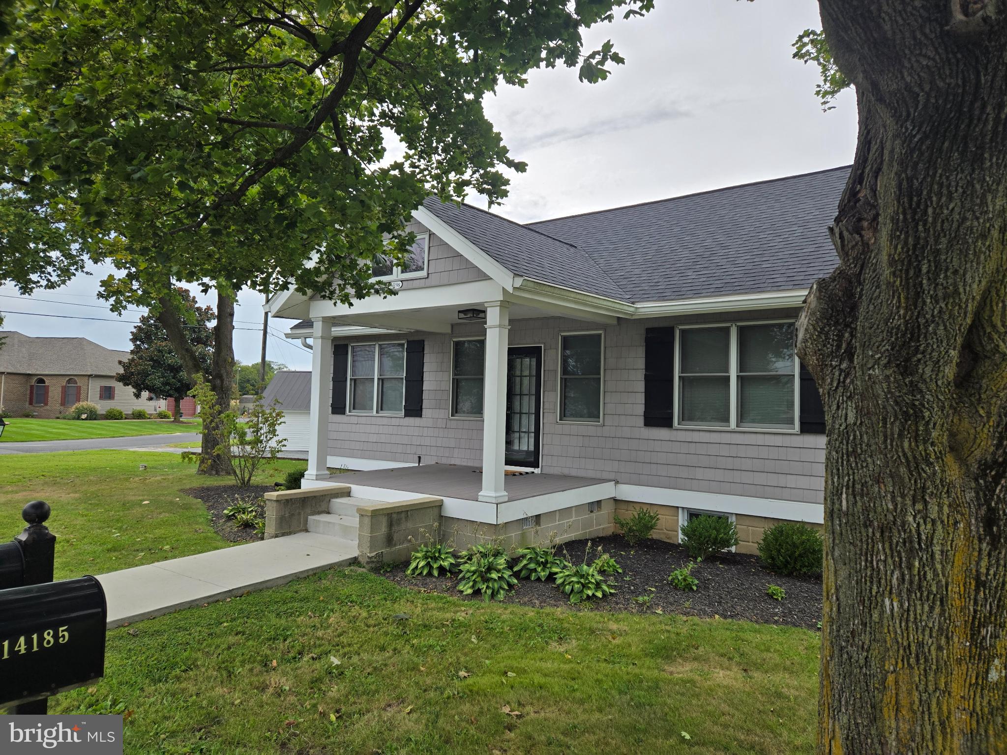 14198 Union Street Milton, DE 19968 - Photo 7 of 49 Charming home with inviting porch and greenery.