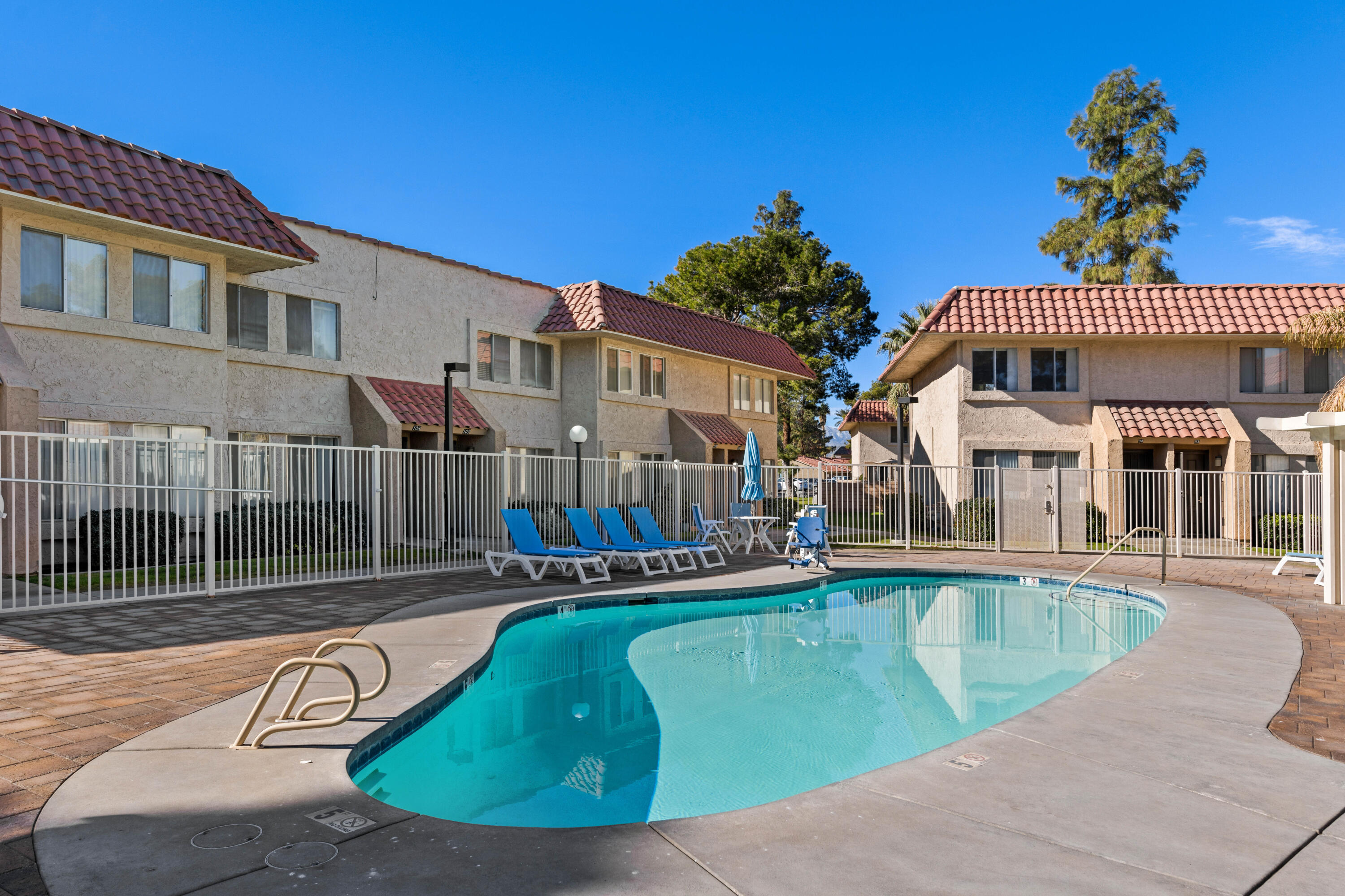 82567 Ave 48, Unit 103 Indio, CA 92201 - Photo 15 of 26 a view of a house with a swimming pool
