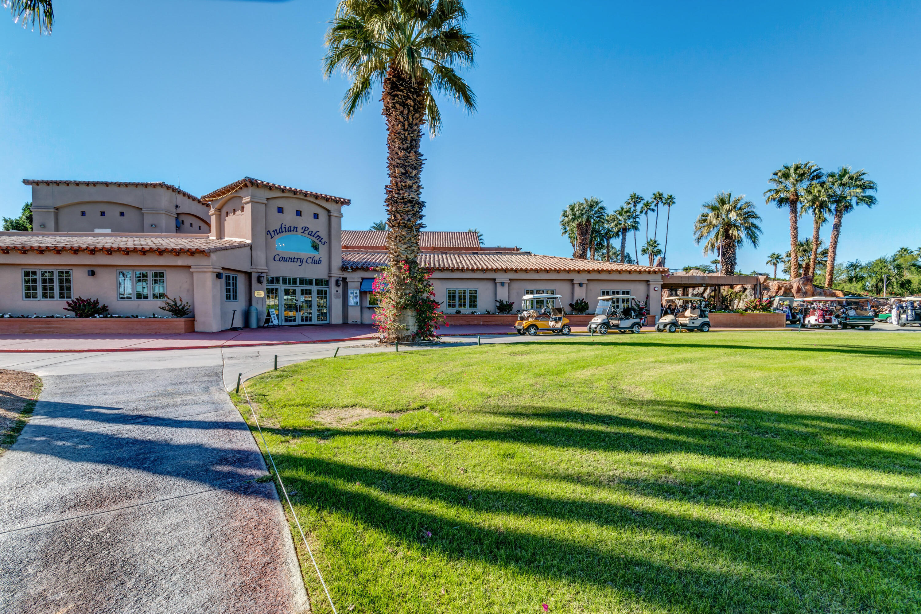 82567 Ave 48, Unit 103 Indio, CA 92201 - Photo 18 of 26 a front view of a building with garden and trees