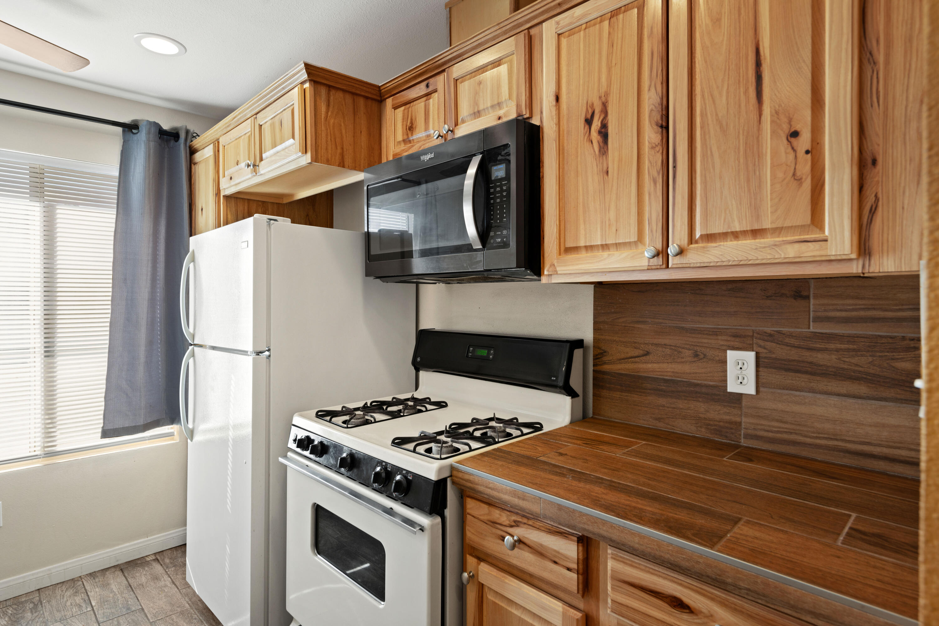 82567 Ave 48, Unit 103 Indio, CA 92201 - Photo 6 of 26 a kitchen with a stove and a refrigerator