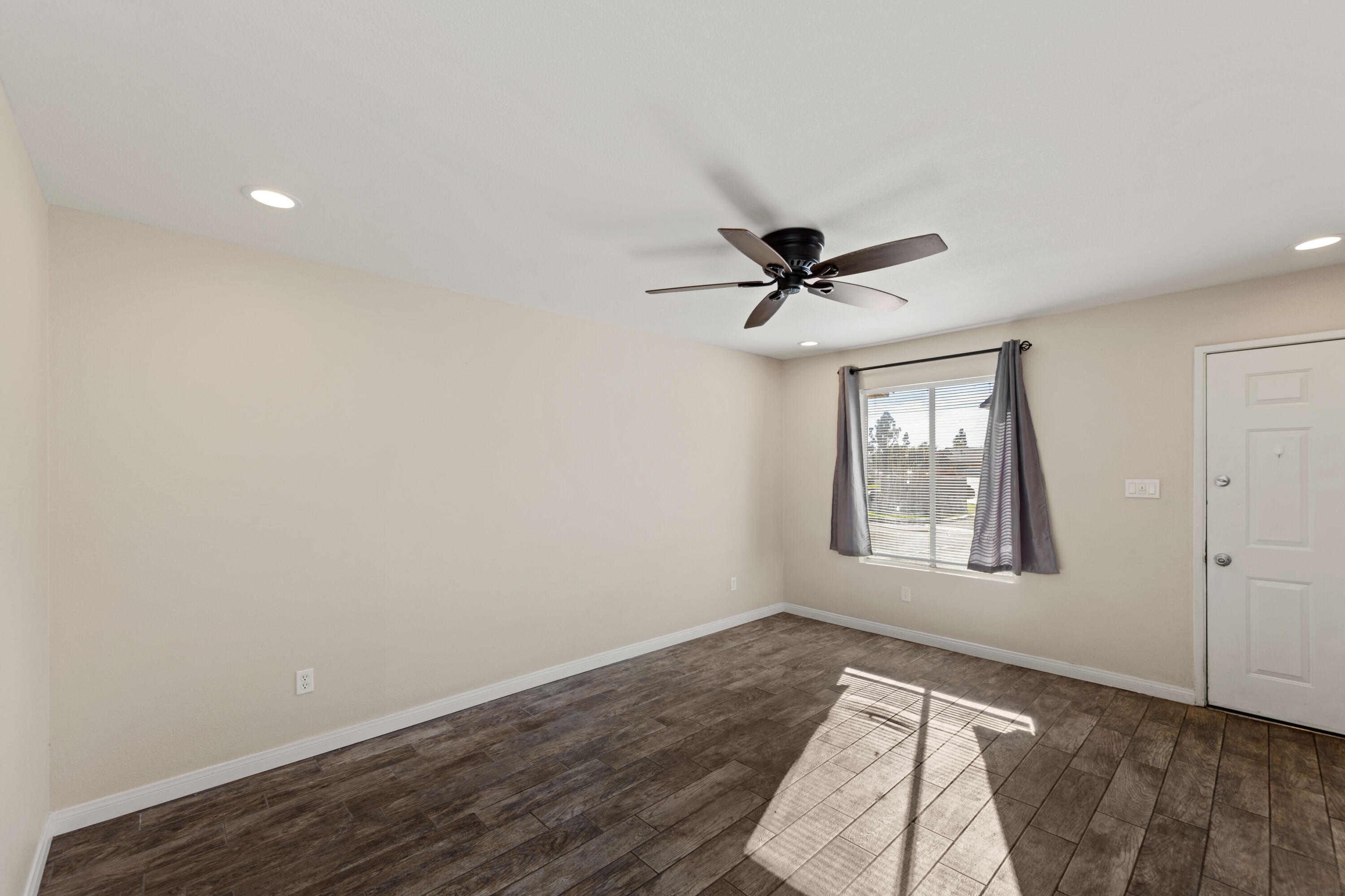 82567 Ave 48, Unit 103 Indio, CA 92201 - Photo 8 of 26 a view of empty room with wooden floor and fan