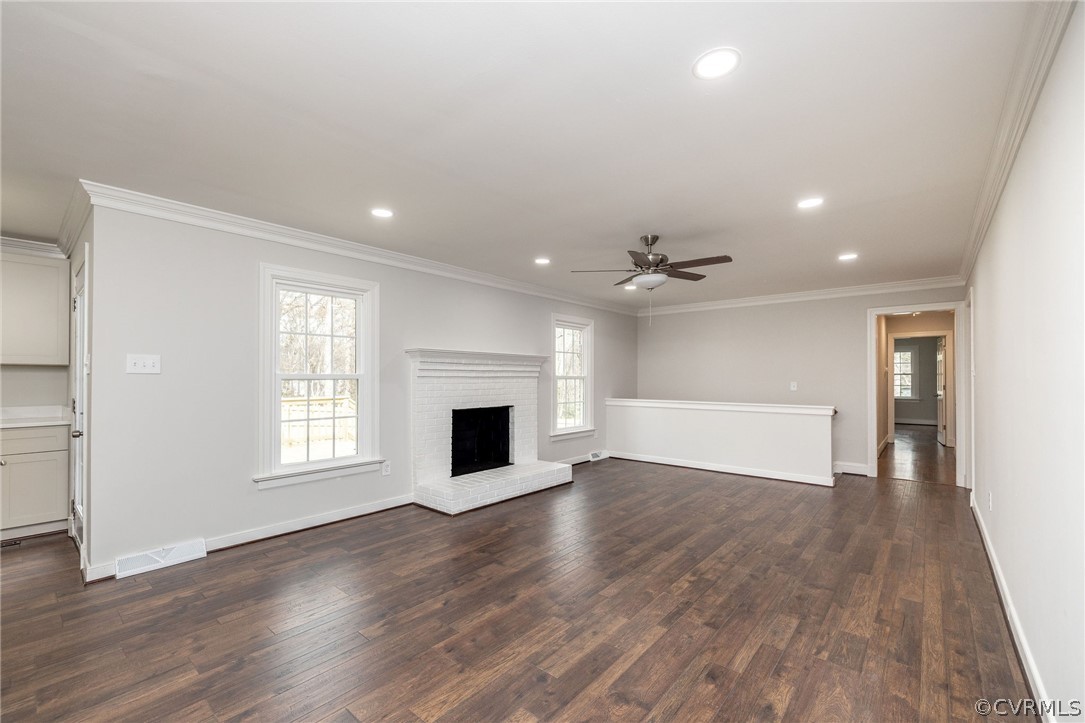 11633 Boyd Road Chester, VA 23831 - Photo 13 of 49 an empty room with wooden floor ceiling fan and windows