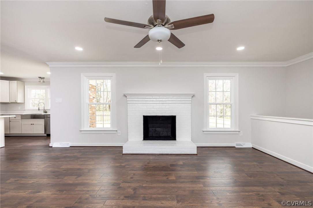 11633 Boyd Road Chester, VA 23831 - Photo 14 of 49 an empty room with wooden floor fireplace and windows
