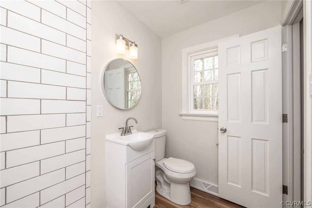 11633 Boyd Road Chester, VA 23831 - Photo 31 of 49 a bathroom with a sink a toilet and a mirror