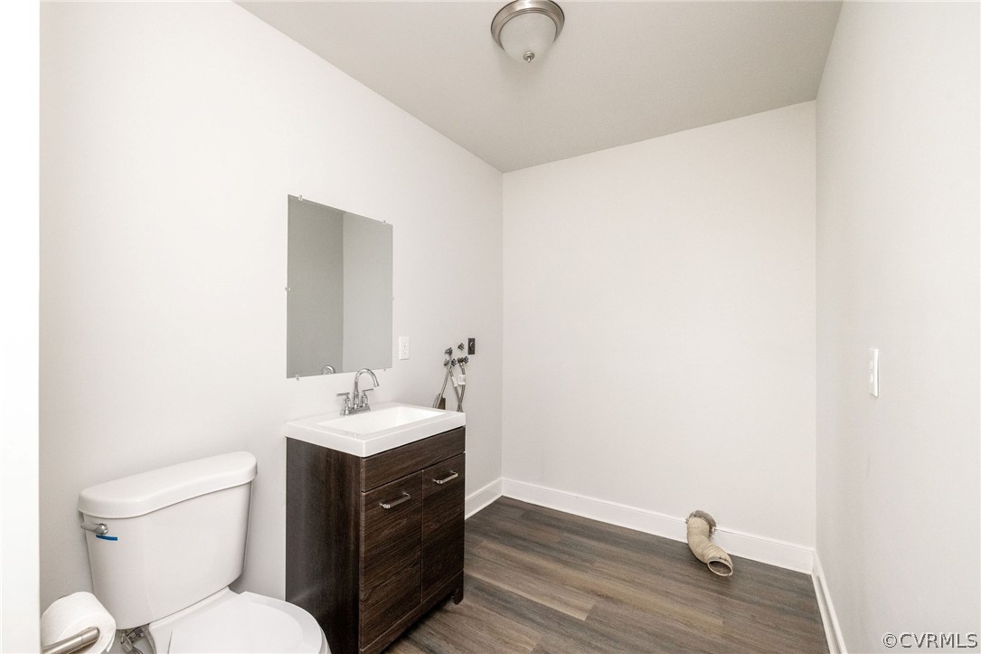 11633 Boyd Road Chester, VA 23831 - Photo 43 of 49 a bathroom with a sink toilet a mirror and vanity