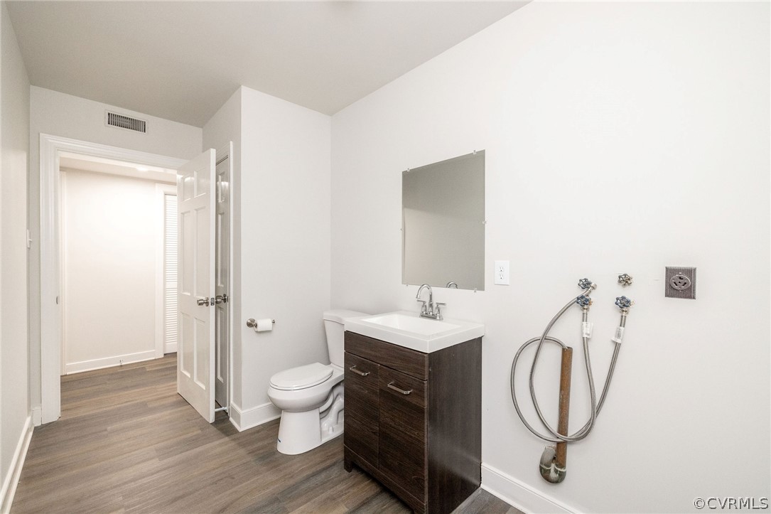 11633 Boyd Road Chester, VA 23831 - Photo 44 of 49 a spacious bathroom with a toilet a sink and a mirror
