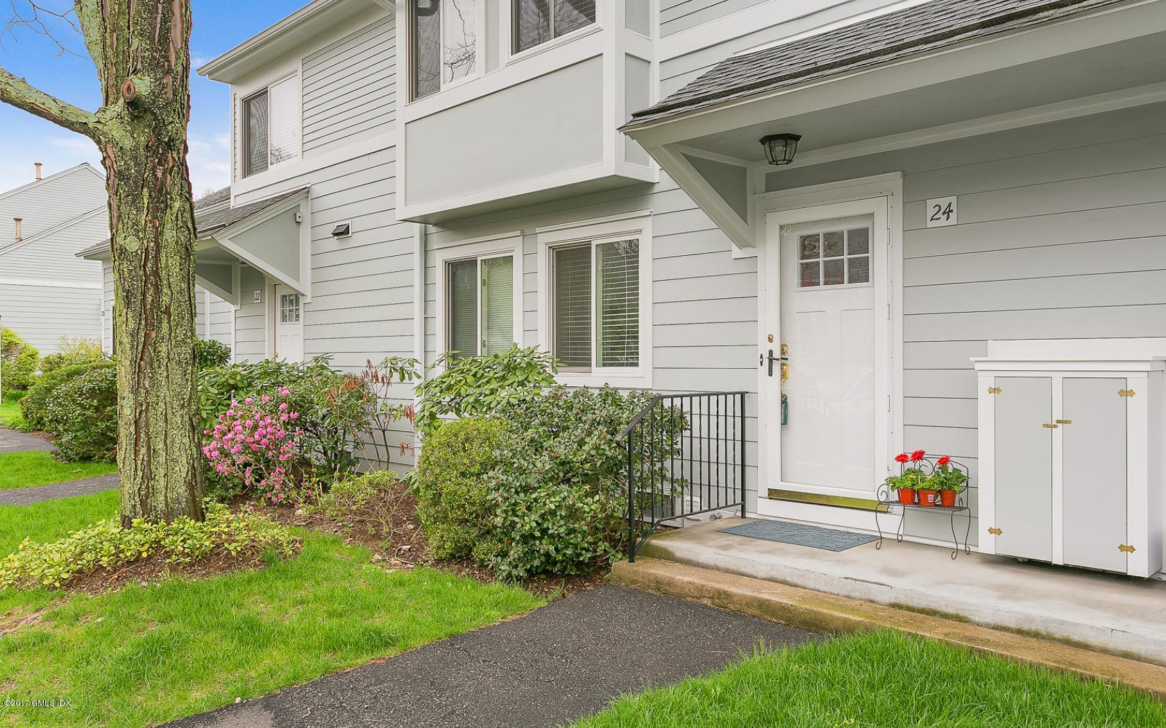 24 Whiffletree Way, Unit 24 Riverside, CT 06878 - Photo 1 of 29 a front view of a house with a yard