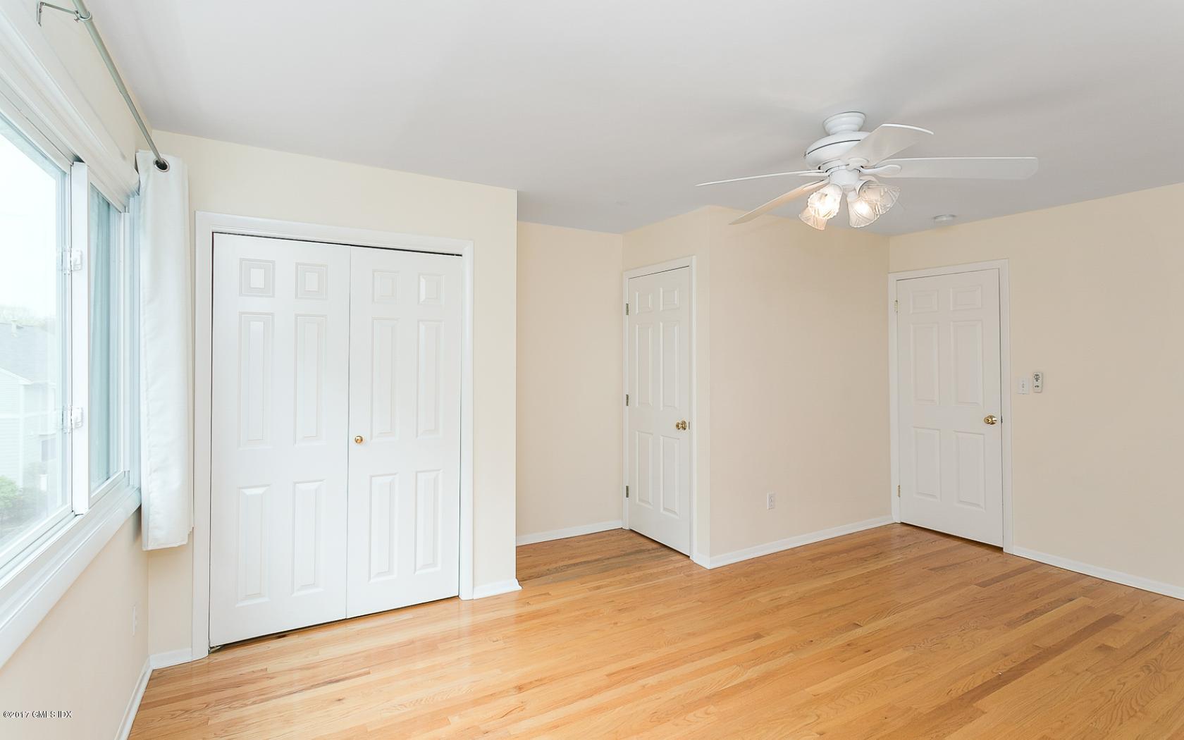 24 Whiffletree Way, Unit 24 Riverside, CT 06878 - Photo 13 of 29 a view of empty room with wooden floor and ceiling fan