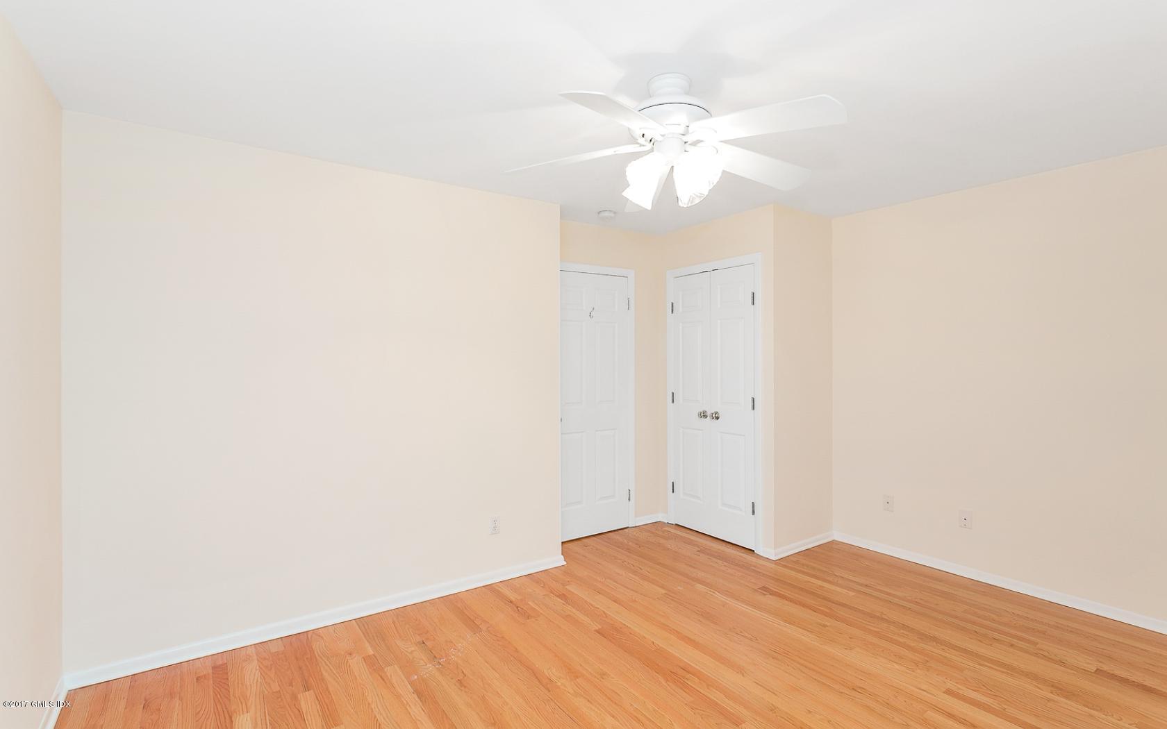 24 Whiffletree Way, Unit 24 Riverside, CT 06878 - Photo 15 of 29 a view of empty room with wooden floor