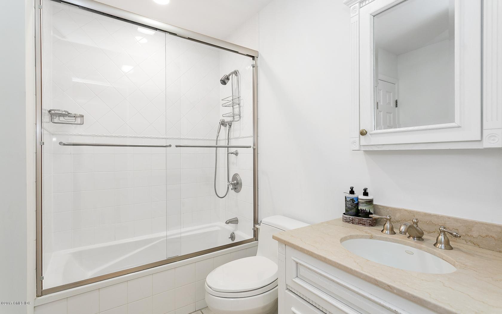24 Whiffletree Way, Unit 24 Riverside, CT 06878 - Photo 19 of 29 a bathroom with a granite countertop sink toilet and shower