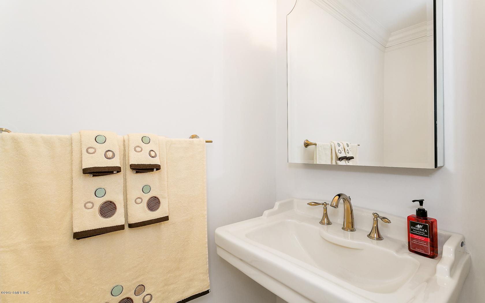 24 Whiffletree Way, Unit 24 Riverside, CT 06878 - Photo 22 of 29 a bathroom with a sink and a mirror