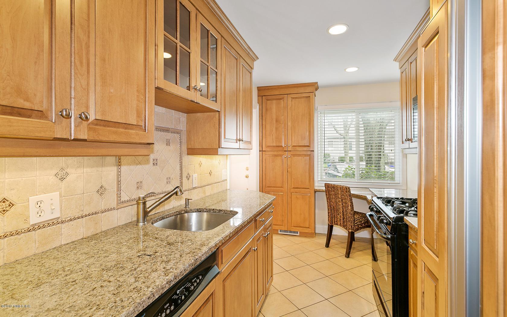 24 Whiffletree Way, Unit 24 Riverside, CT 06878 - Photo 4 of 29 a kitchen with a sink a counter and a refrigerator