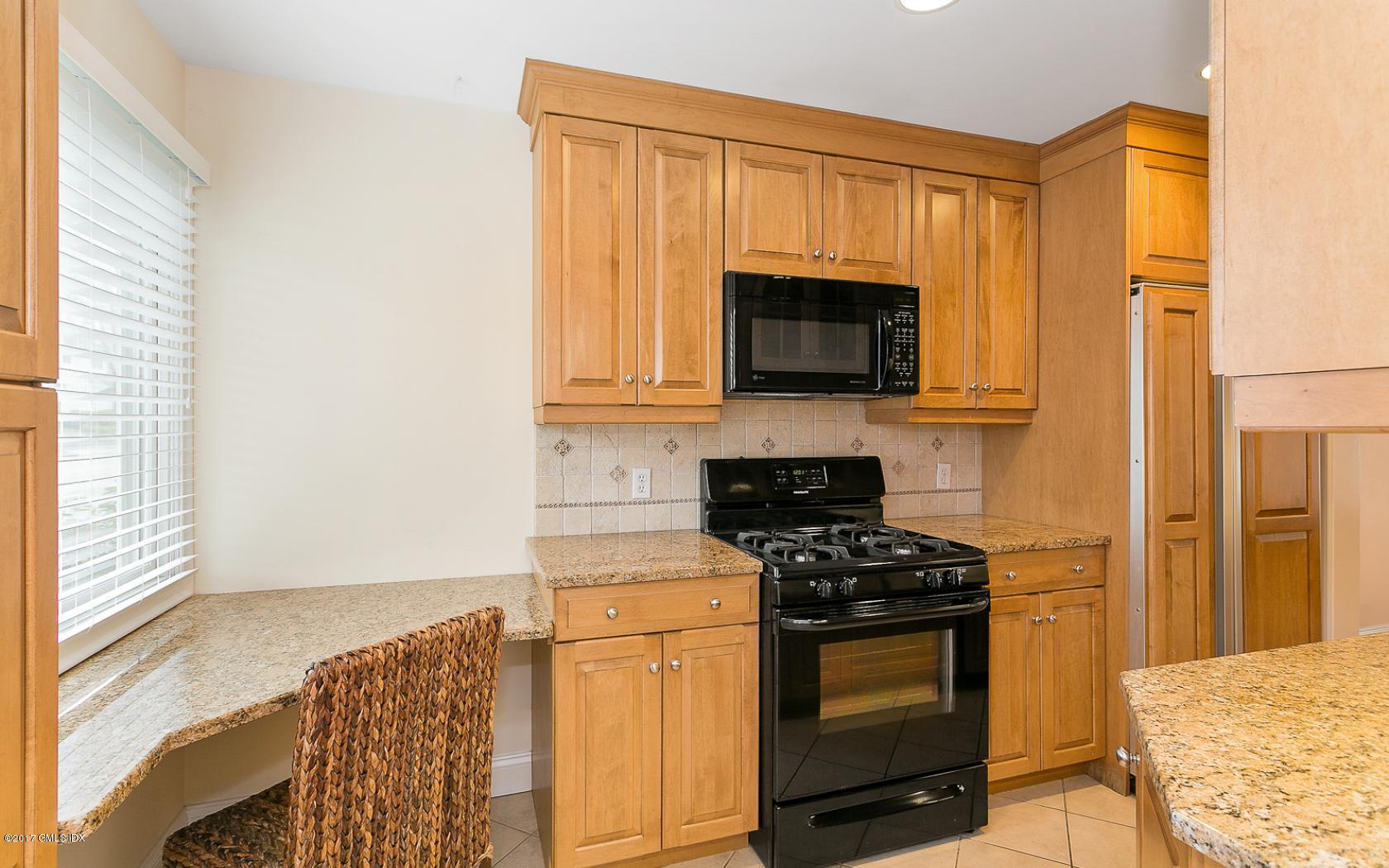 24 Whiffletree Way, Unit 24 Riverside, CT 06878 - Photo 6 of 29 a kitchen with stainless steel appliances a stove a microwave and sink