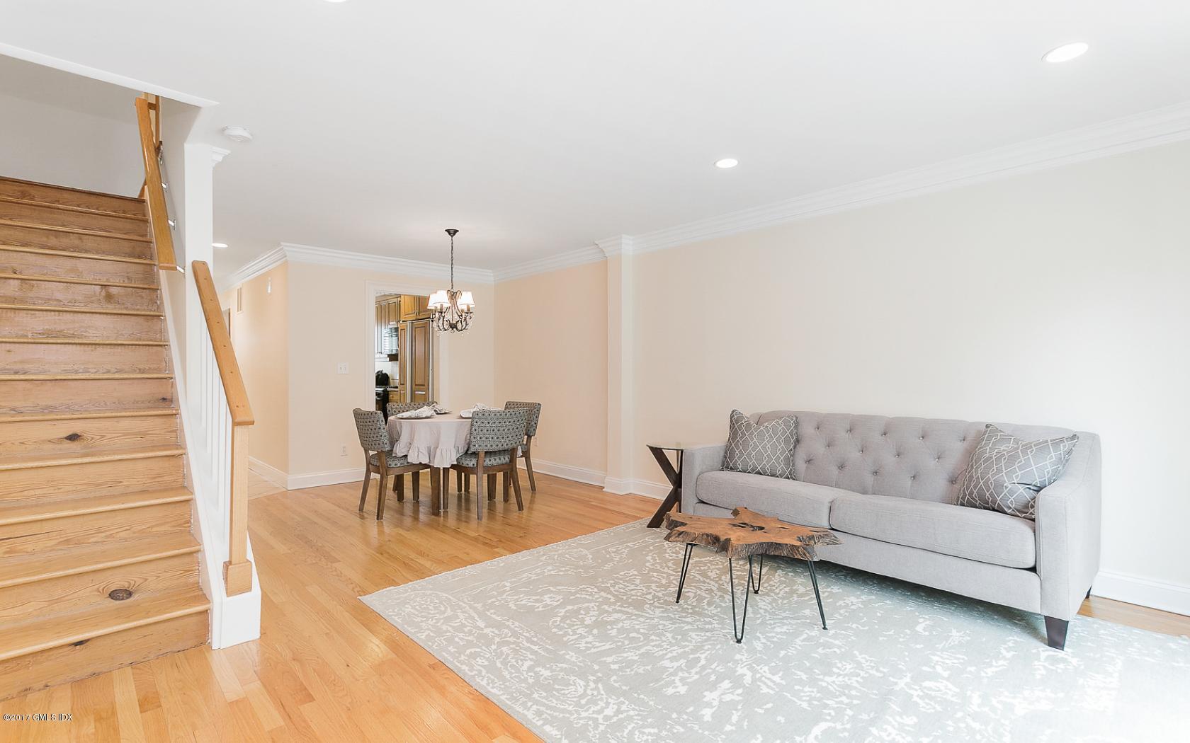 24 Whiffletree Way, Unit 24 Riverside, CT 06878 - Photo 9 of 29 a living room with furniture and a dining table