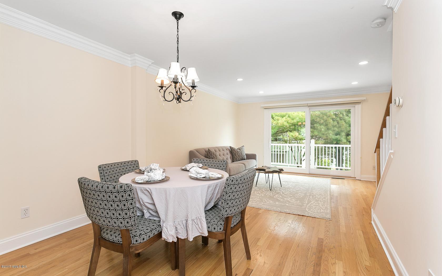 24 Whiffletree Way, Unit 24 Riverside, CT 06878 - Photo 10 of 29 a dining room with furniture a chandelier and wooden floor