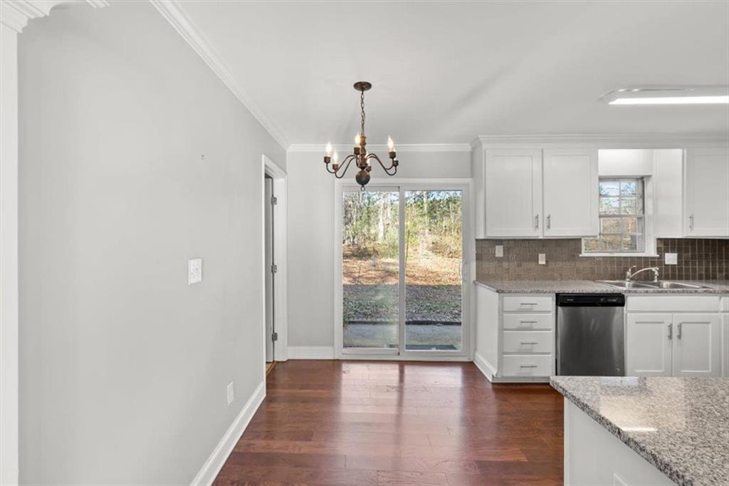 81 Russell Drive Northeast Rome, GA 30165 - Photo 20 of 38 a kitchen with kitchen island granite countertop a stove cabinets and wooden floor