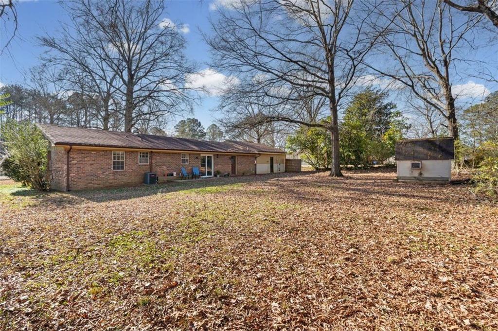 81 Russell Drive Northeast Rome, GA 30165 - Photo 34 of 38 a front view of a house with a yard and garage
