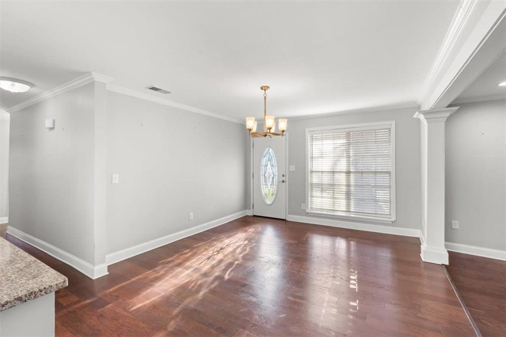 81 Russell Drive Northeast Rome, GA 30165 - Photo 7 of 38 an empty room with wooden floor and windows