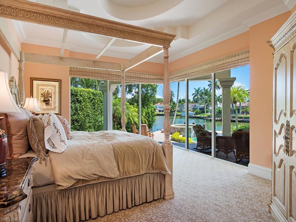 419 Mooring Line Drive Naples, FL 34102 - Photo 11 of 16 a bedroom with a bed and large window