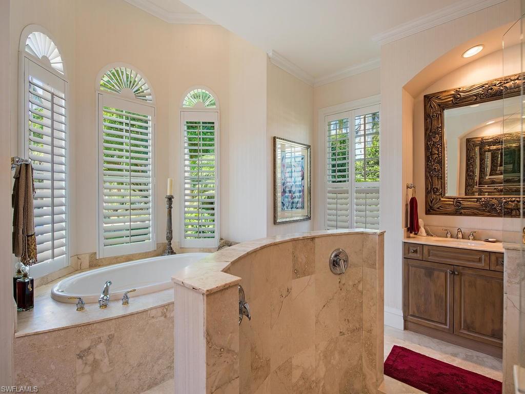 419 Mooring Line Drive Naples, FL 34102 - Photo 13 of 16 a bathroom with a tub sink and mirror