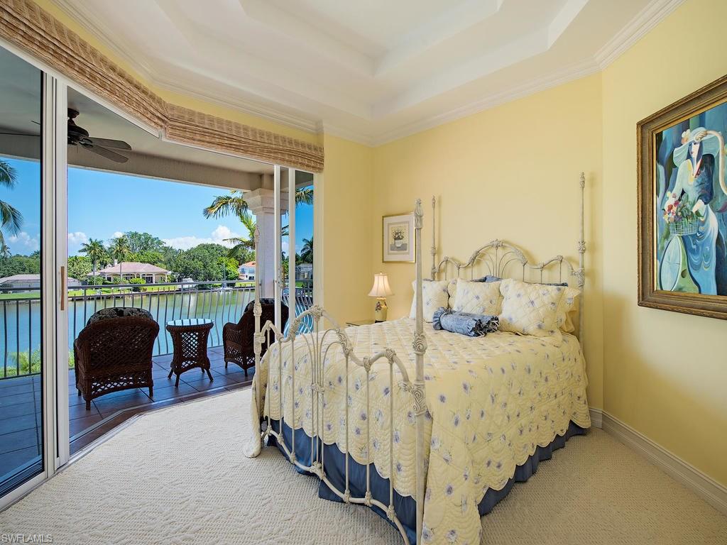 419 Mooring Line Drive Naples, FL 34102 - Photo 14 of 16 a bedroom with a bed couch and a window