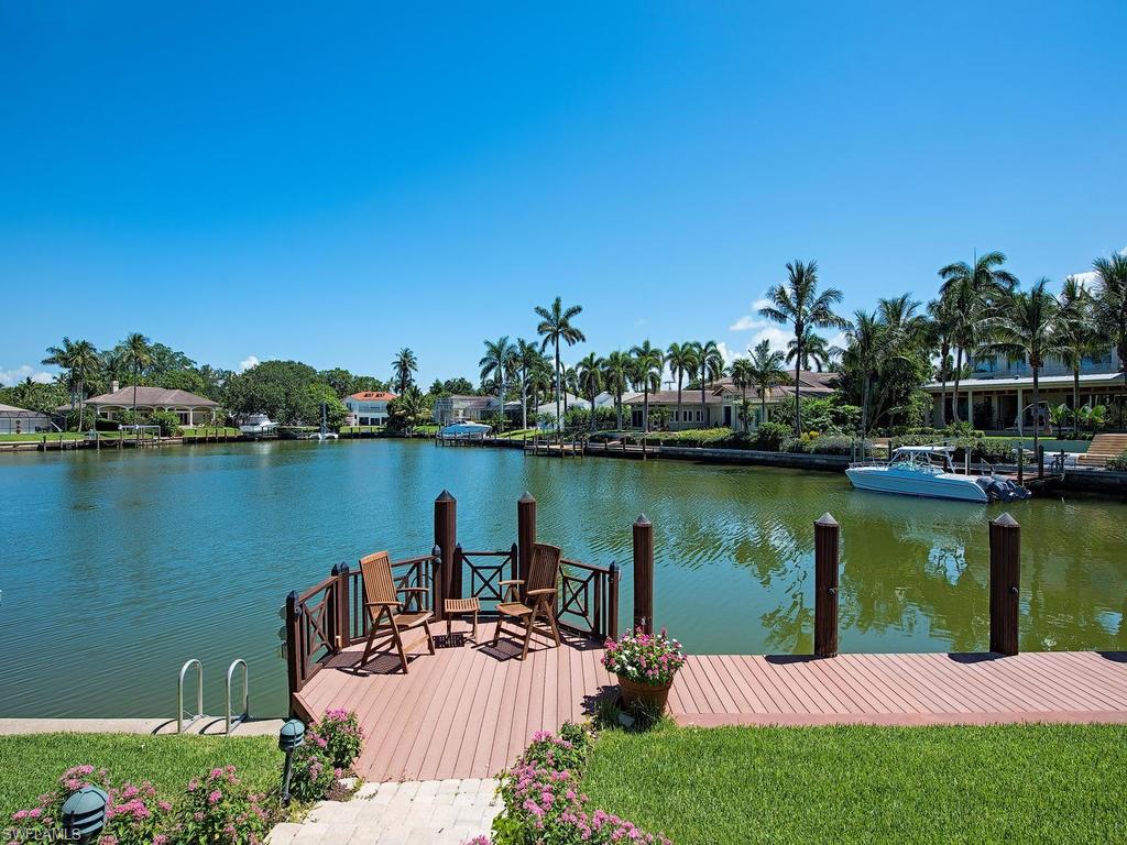 419 Mooring Line Drive Naples, FL 34102 - Photo 4 of 16 a view of a lake with houses