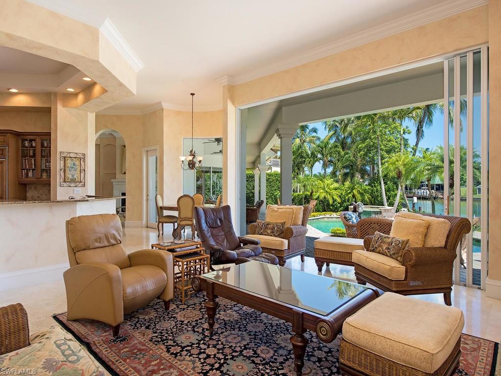 419 Mooring Line Drive Naples, FL 34102 - Photo 6 of 16 a living room with furniture and a large window