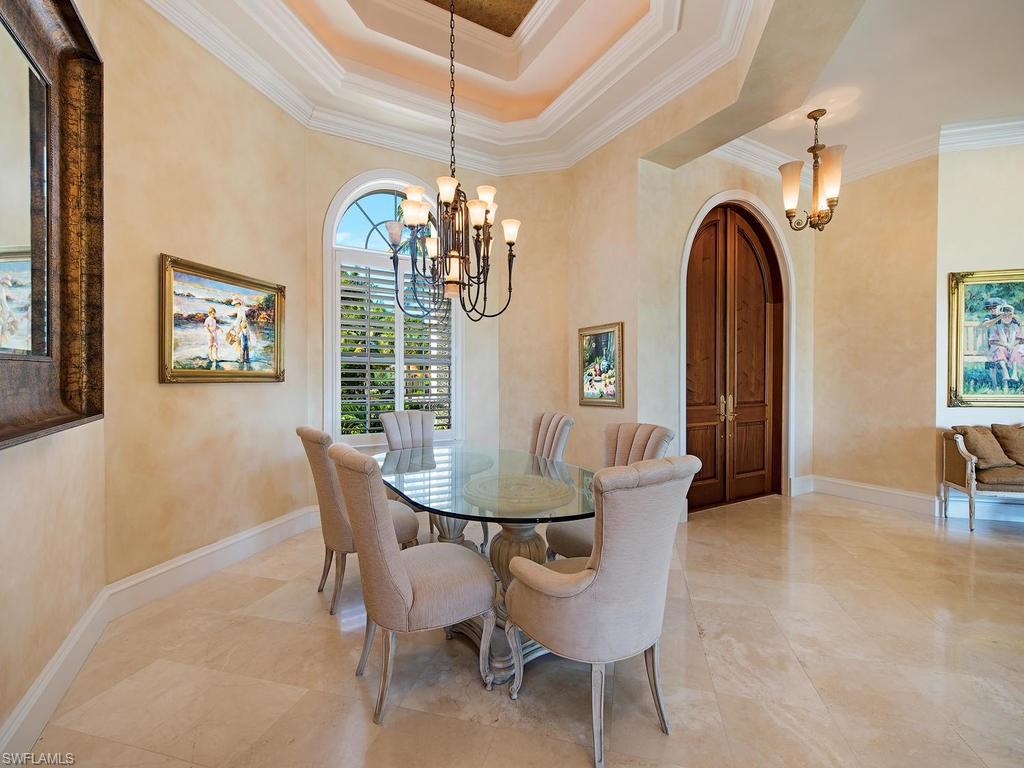 419 Mooring Line Drive Naples, FL 34102 - Photo 9 of 16 a dining room with furniture a chandelier and window