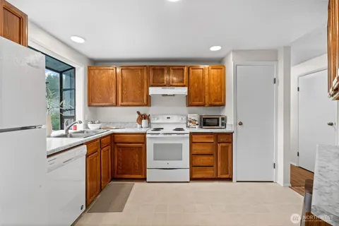 a kitchen with a refrigerator sink stove and microwave