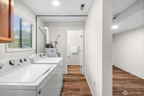 a view of a room with wooden floor