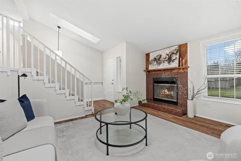 a living room with furniture a rug and a large window