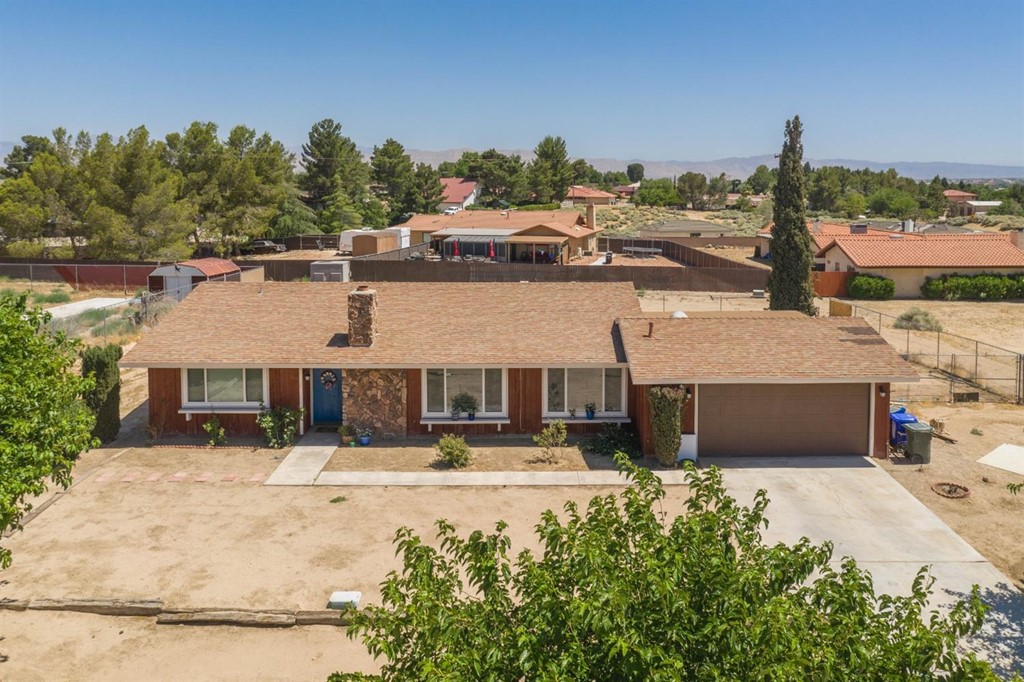 18615 Mingo Road Apple Valley, CA 92307 - Photo 1 of 1 a front view of a house with a yard