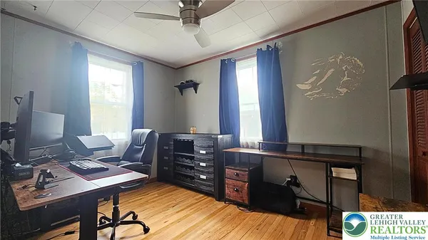 a view of a workspace with furniture and a window