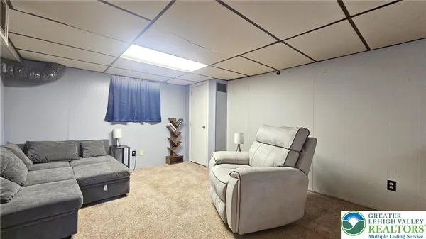 a bedroom with double bed and a couch