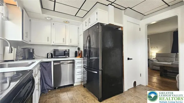 a kitchen with a refrigerator and a sink