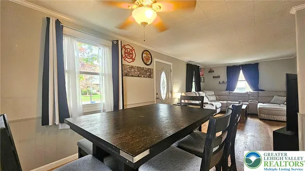 a living room with dining table and a large window