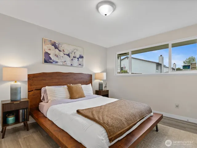 a bedroom with a bed and wall painting