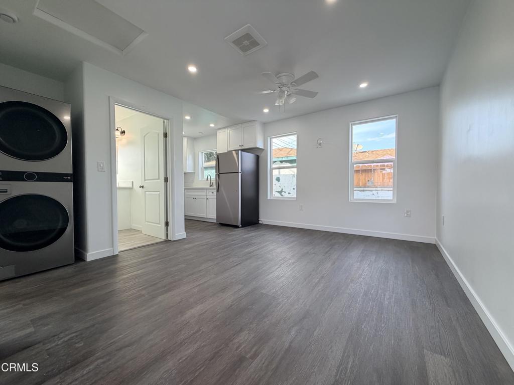 945 South H Street, Unit B Oxnard, CA 93030 - Photo 2 of 4 a view of a kitchen with a fridge wooden floor and window