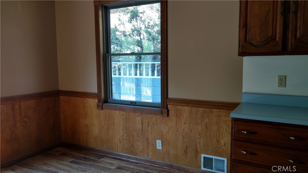 1792 Ash Road Wrightwood, CA 92397 - Photo 39 of 51 a view of an empty room with wooden floor and a window