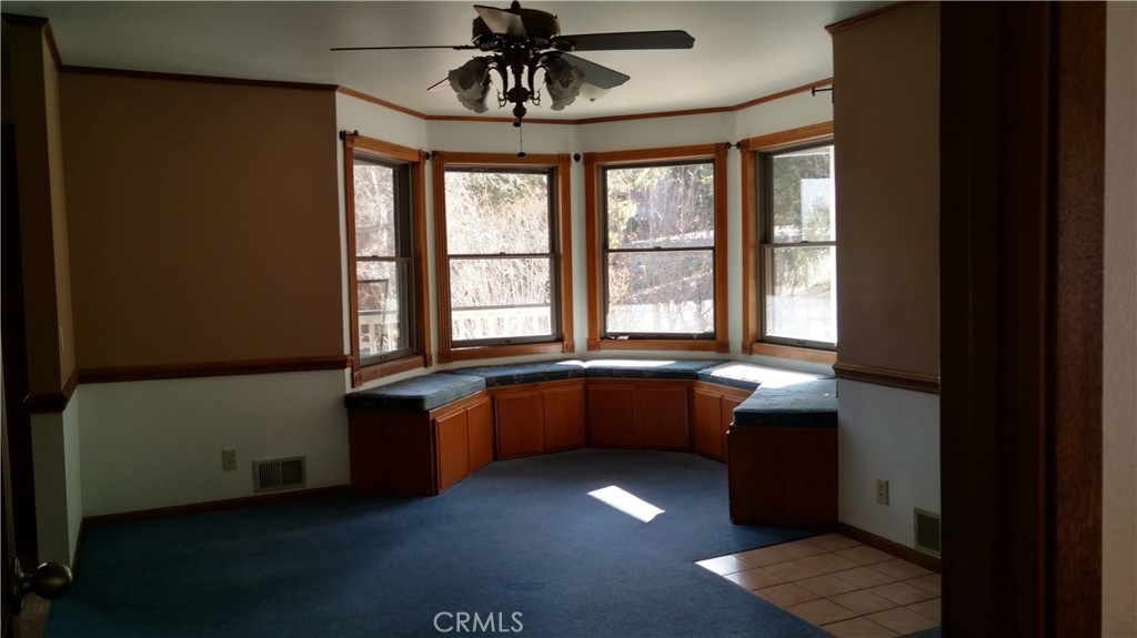 1792 Ash Road Wrightwood, CA 92397 - Photo 9 of 51 a large kitchen with a table chairs and a refrigerator