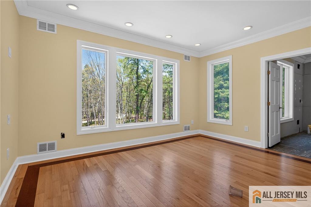 381 Monmouth Road Freehold, NJ 07728 - Photo 25 of 63 a view of an empty room with wooden floor and a window