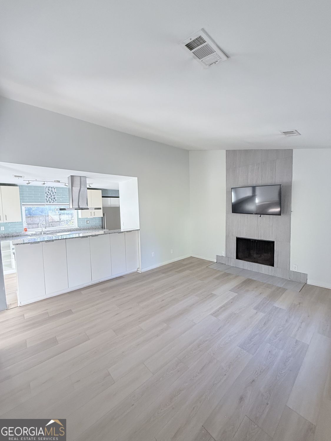 477 Benton Court Southwest Lawrenceville, GA 30044 - Photo 3 of 17 a view of a kitchen with granite countertop cabinets and a wooden floor