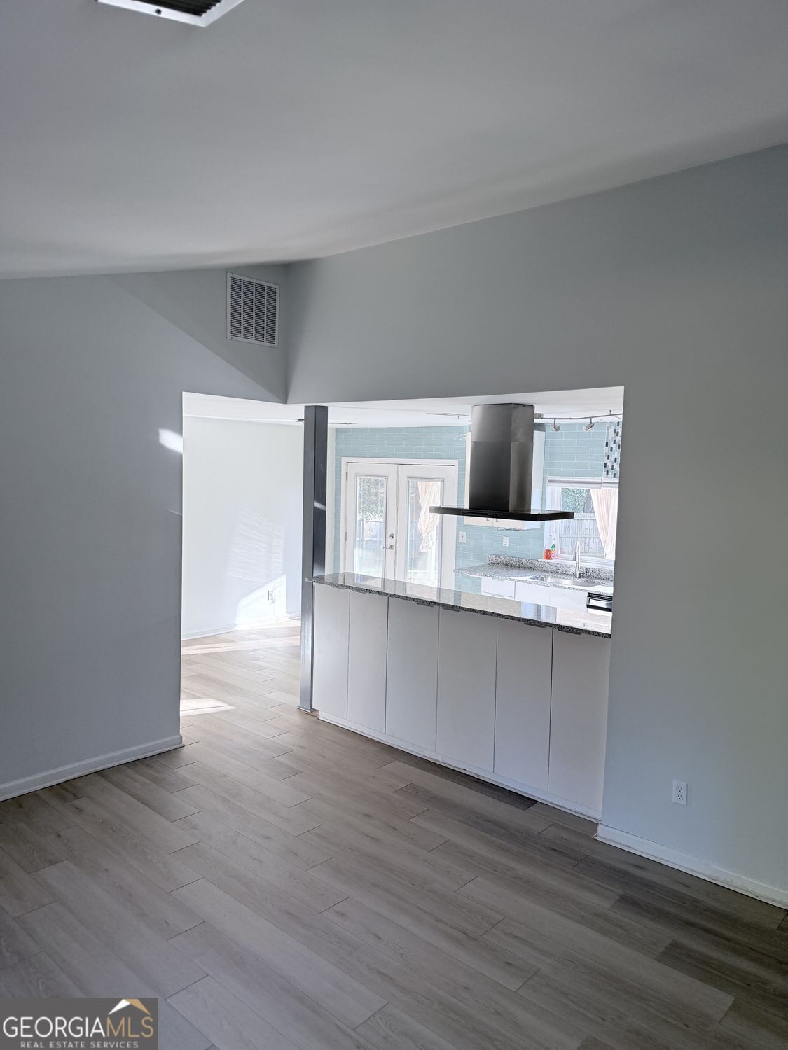 477 Benton Court Southwest Lawrenceville, GA 30044 - Photo 5 of 17 a kitchen with a wooden floor and electronic appliances