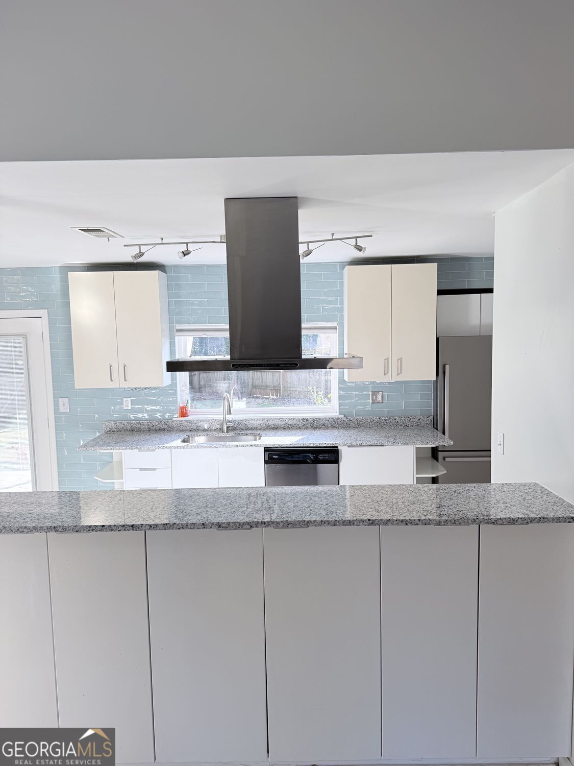 477 Benton Court Southwest Lawrenceville, GA 30044 - Photo 7 of 17 a kitchen with granite countertop a sink and a granite counter tops